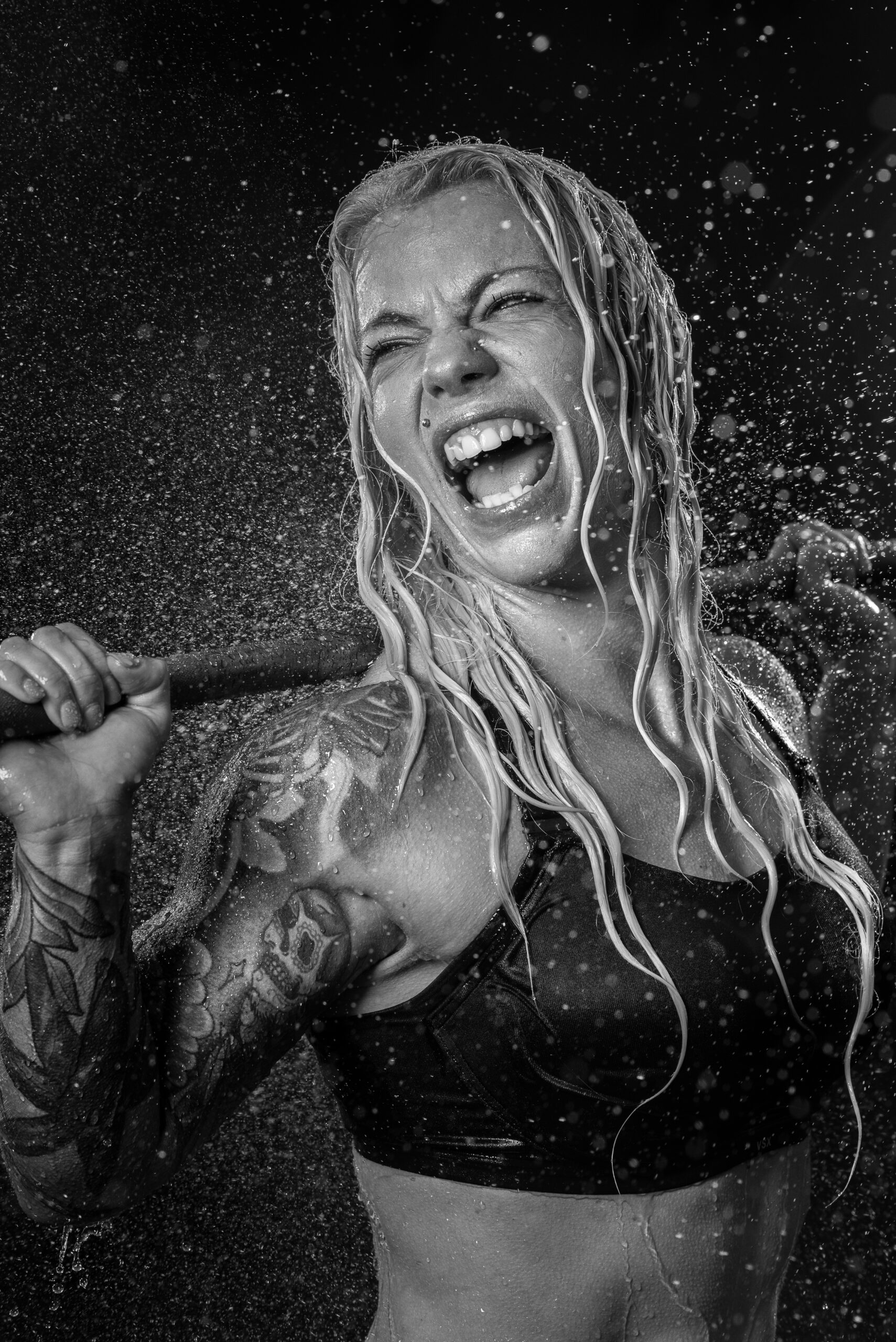 powerful female body builder with water spray